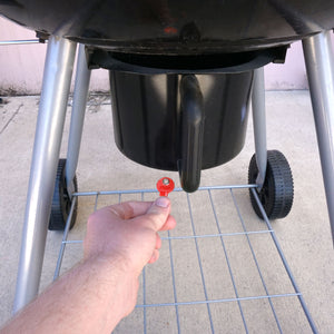 50692 Magnetic Key, M1-69 Red - Hand Holding Red Magnetic Key Beneath a Barbeque Grill