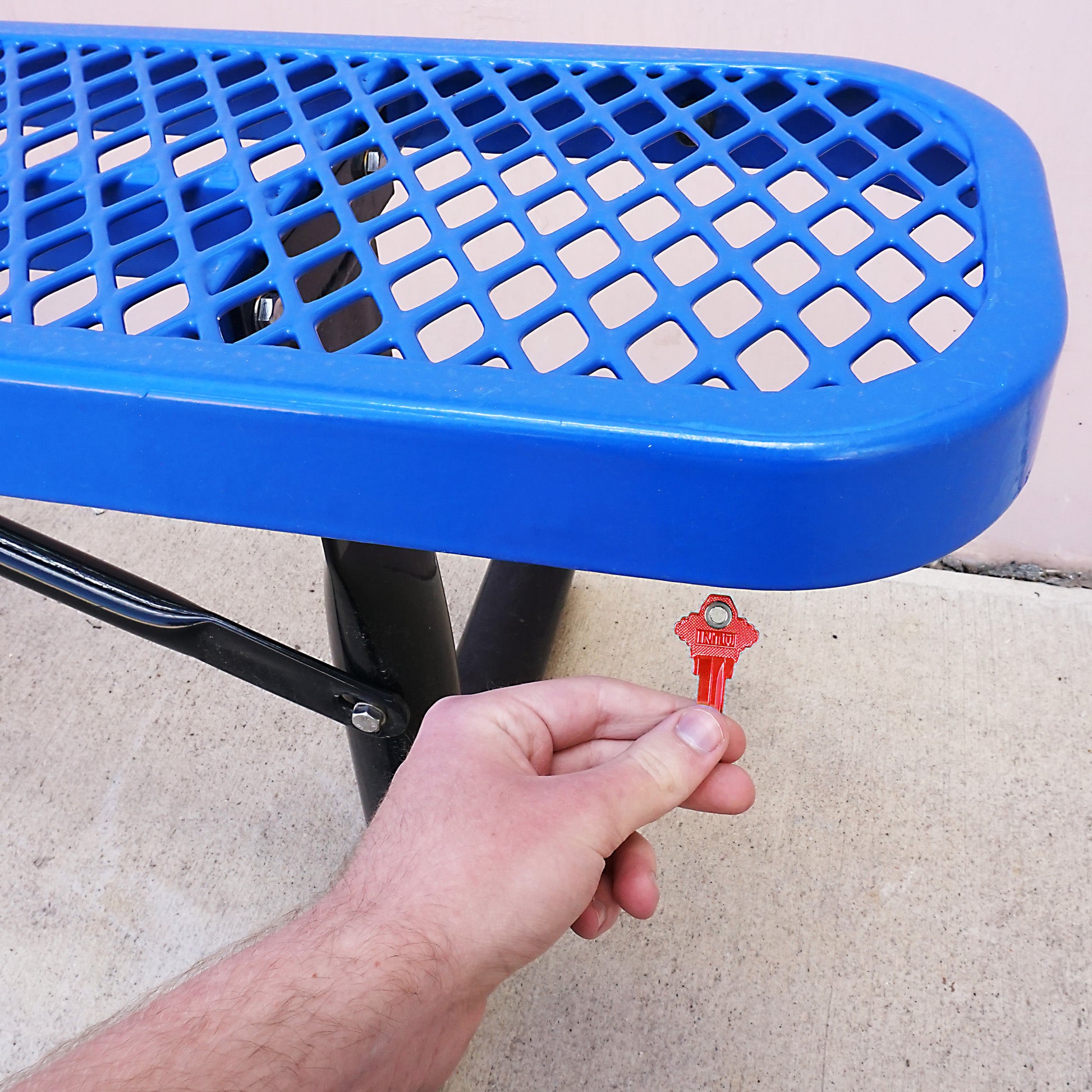 Load image into Gallery viewer, 50682 Magnetic Key, SC1-68 Red - Hand Holding Red Magnetic Key Next to Metal Bench