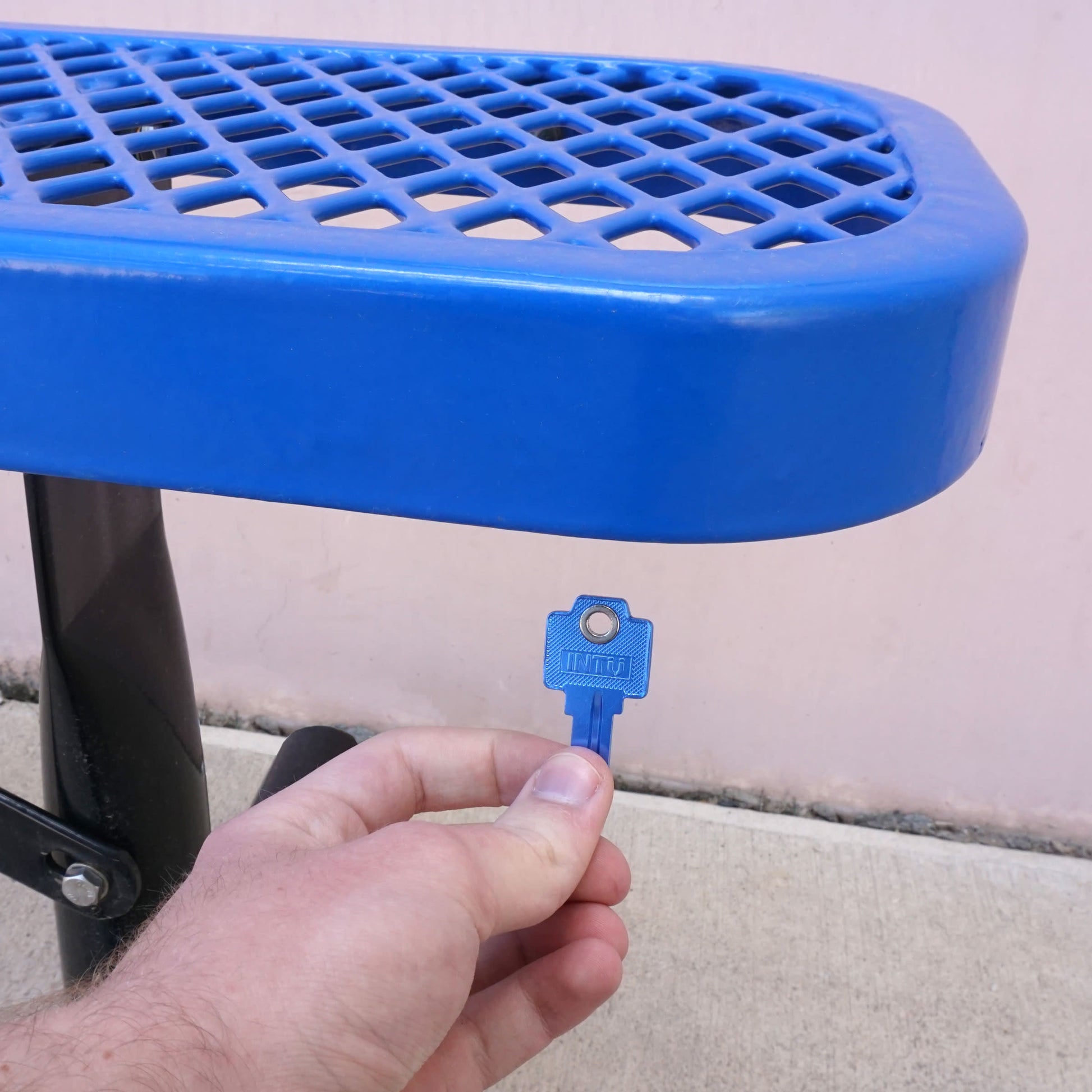 Load image into Gallery viewer, 50773 Magnetic Key, WR5-67 Blue - Hand Holding Blue Magnetic Key Next to a Metal Bench