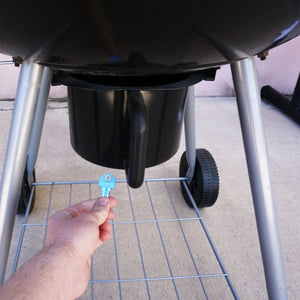 50773 Magnetic Key, WR5-67 Blue - Hand Holding Blue Magnetic Key Beneath a Barbeque Grill