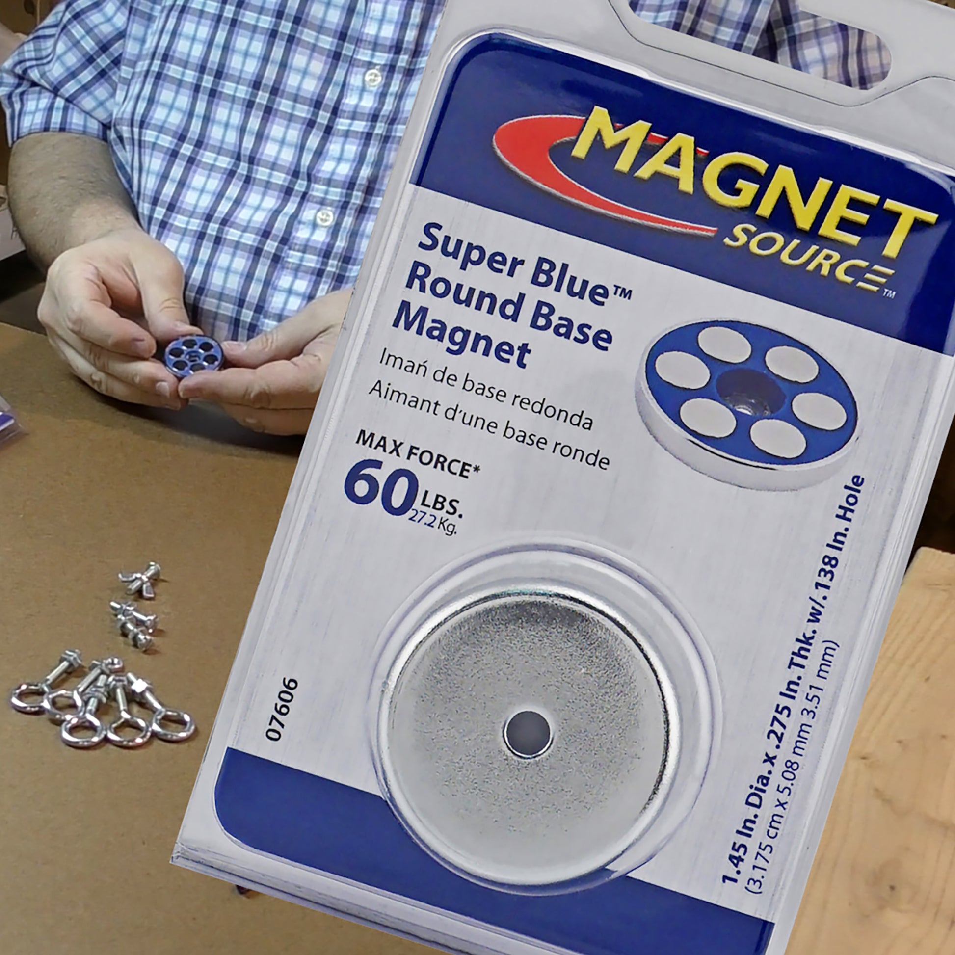 Load image into Gallery viewer, 07606 Super Blue™ Neodymium Round Base Magnet - Packaging with Man Holding Product in Background