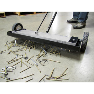 MFSM24RX Magnetic Floor Sweeper with Quick Release - Sweeper picking up metal debris on warehouse floor