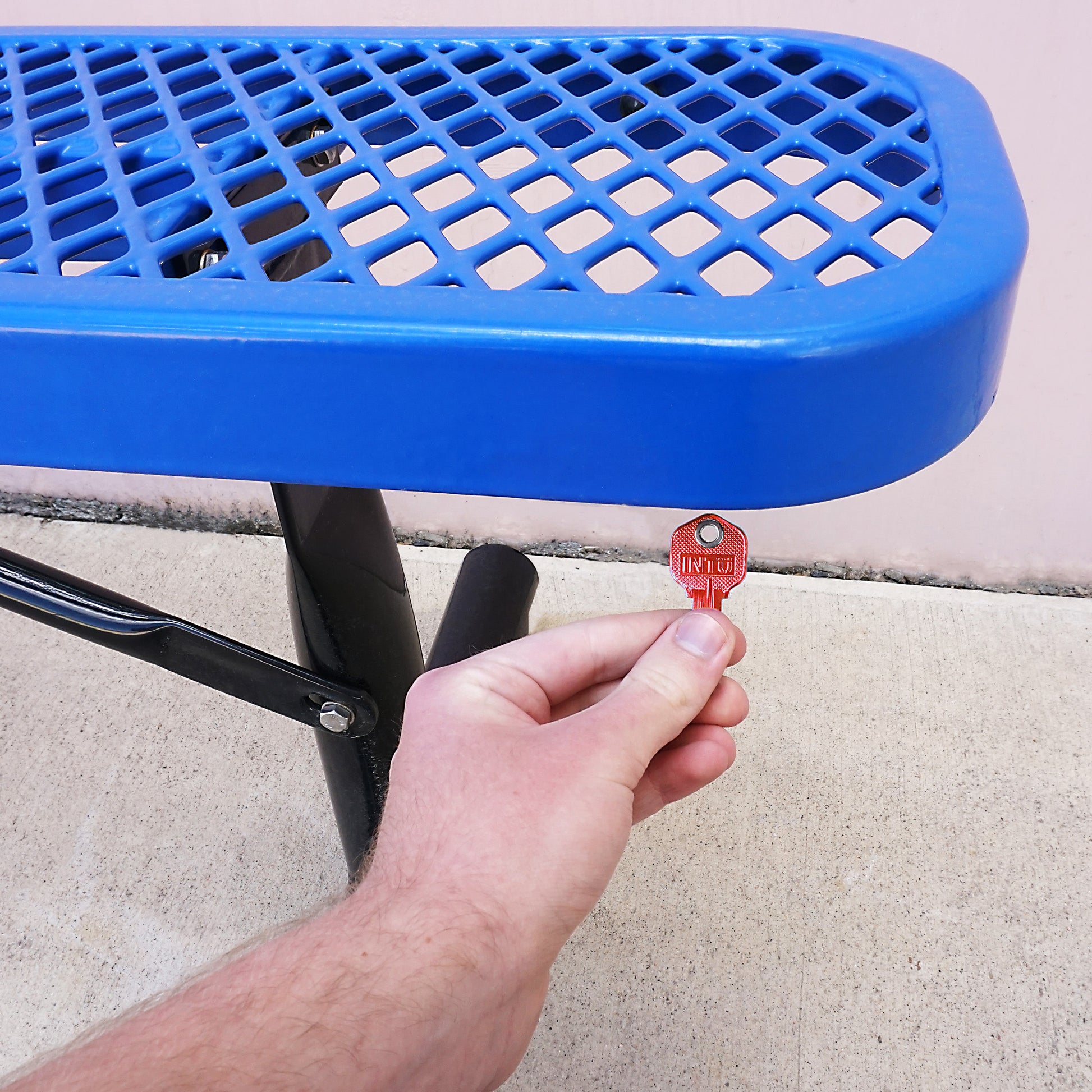 Load image into Gallery viewer, 50662 Magnetic Key, KW1-66 Red - Hand Holding Red Magnetic Key Next to Metal Bench