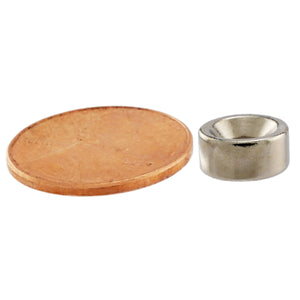 NR002507NCTS Neodymium Countersunk Ring Magnet - Compared to Penny for Size Reference