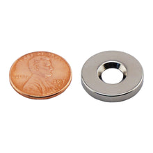 Load image into Gallery viewer, NR005019NCTS Neodymium Countersunk Ring Magnet - Compared to Penny for Size Reference