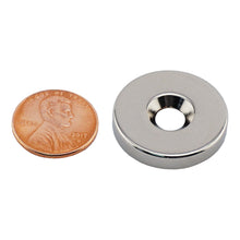Load image into Gallery viewer, NR010021NCTS Neodymium Countersunk Ring Magnet - Compared to Penny for Size Reference
