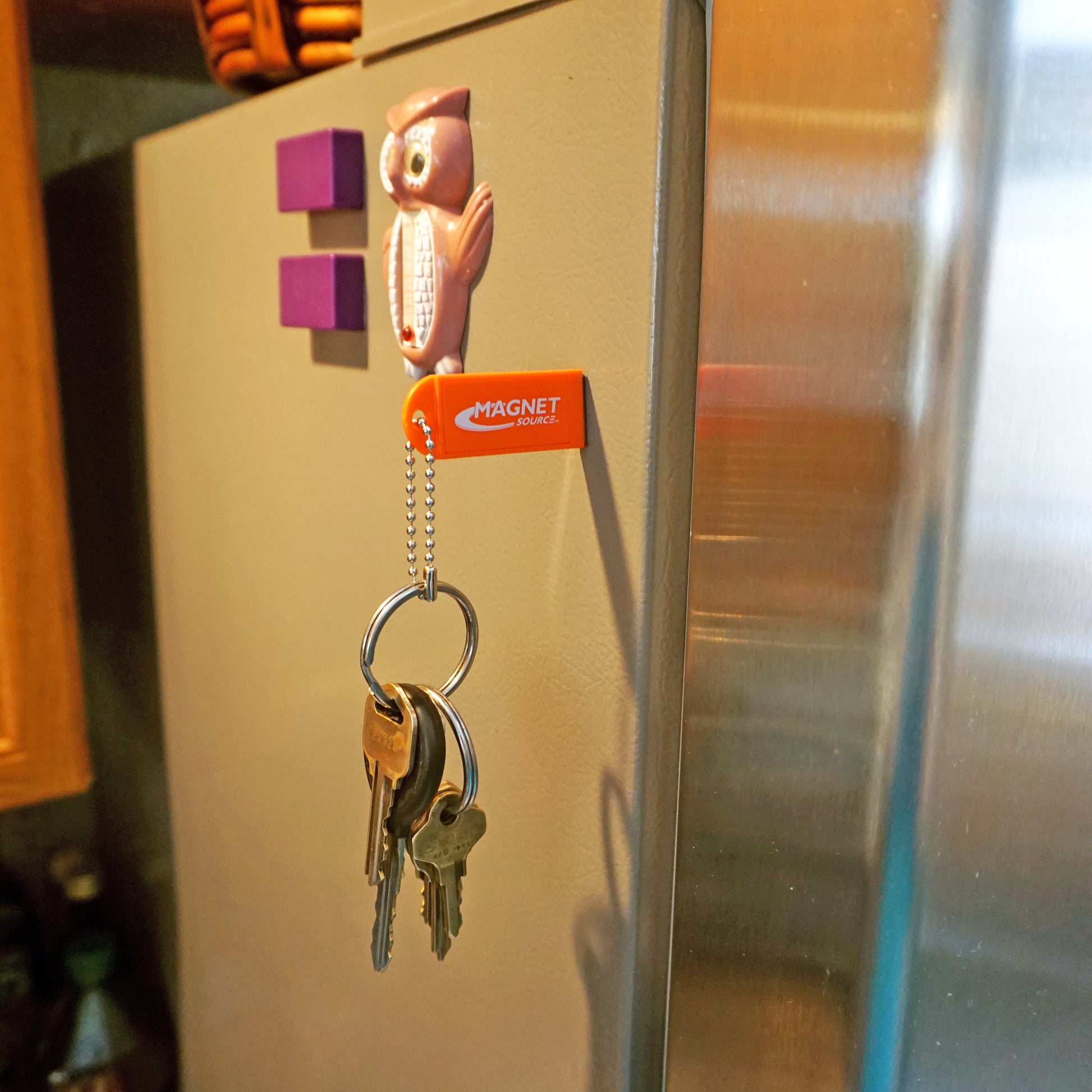 Load image into Gallery viewer, KCMO-BULK Neodymium Key Chain Magnet with Logo, Orange - Orange Magnet on Silver Refrigerator