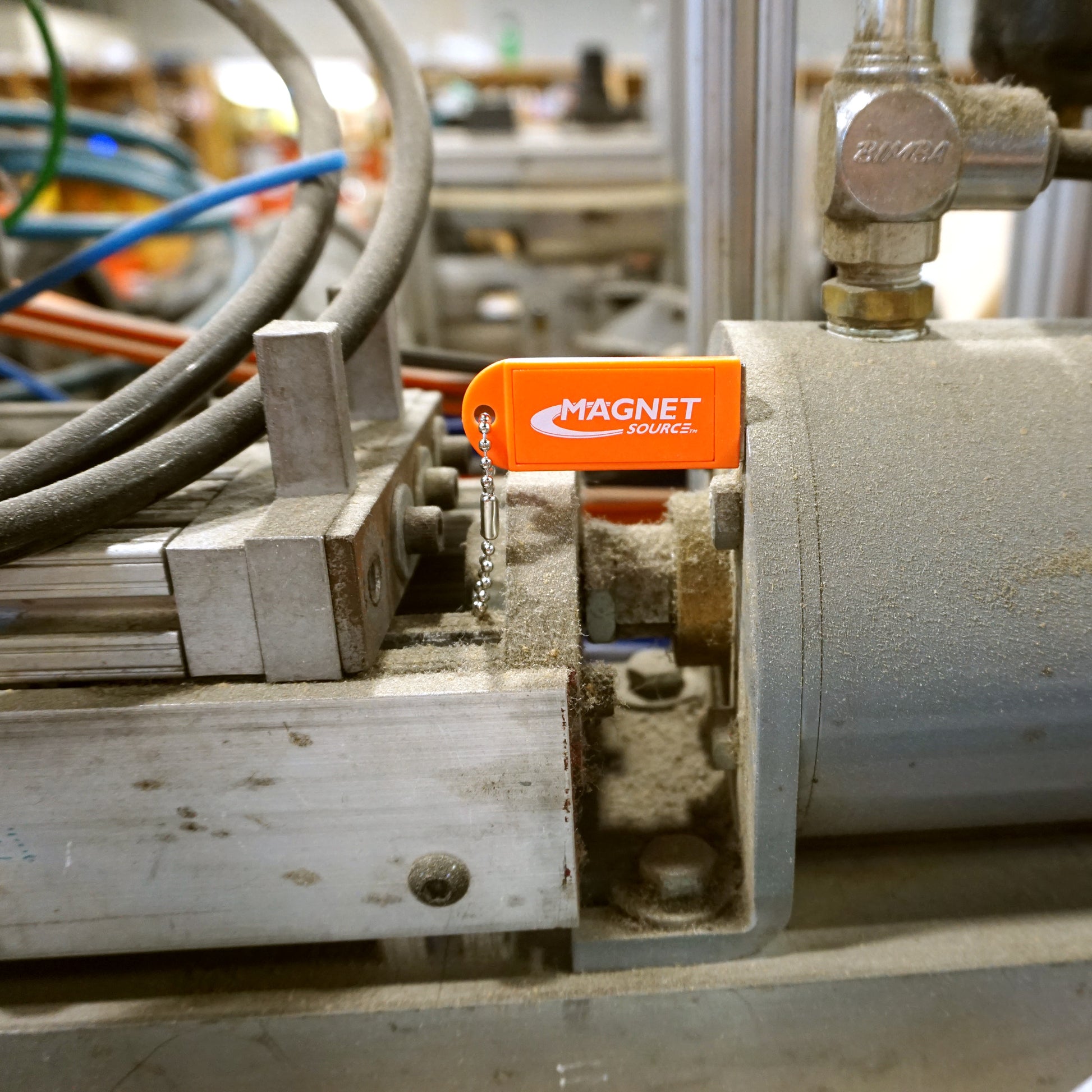 Load image into Gallery viewer, KCMO-BULK Neodymium Key Chain Magnet with Logo, Orange - Testing Orange Magnet on Junk