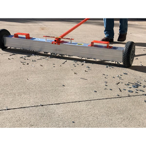 VSM-48 VersaSWEEP™ 4-in-1 Magnetic Sweeper with Quick Release - Closeup View of Man Sweeping Debris Off Sidewalk