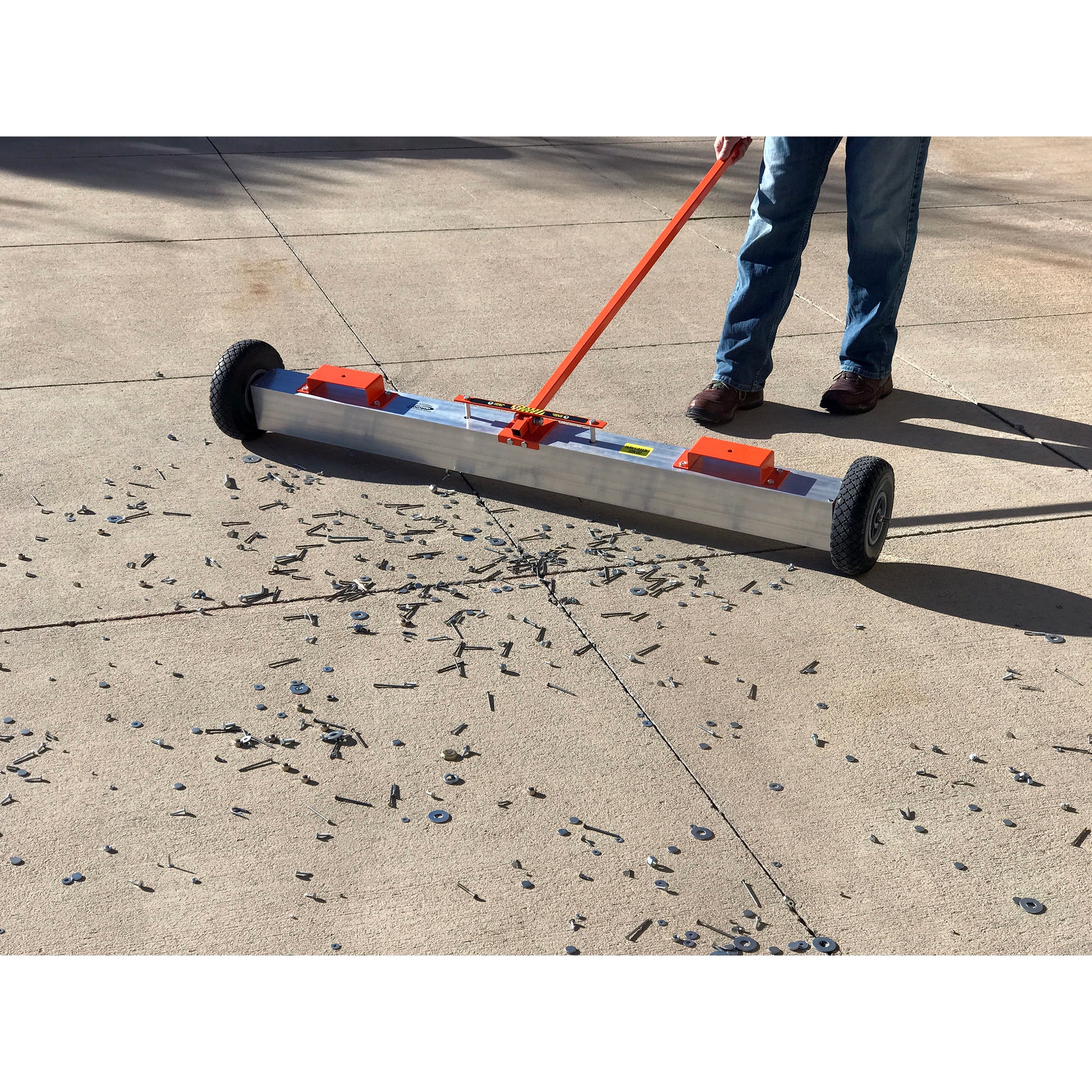 Load image into Gallery viewer, VSM-60 VersaSWEEP™ 4-in-1 Magnetic Sweeper with Quick Release - Man Sweeping Debris off Sidewalk