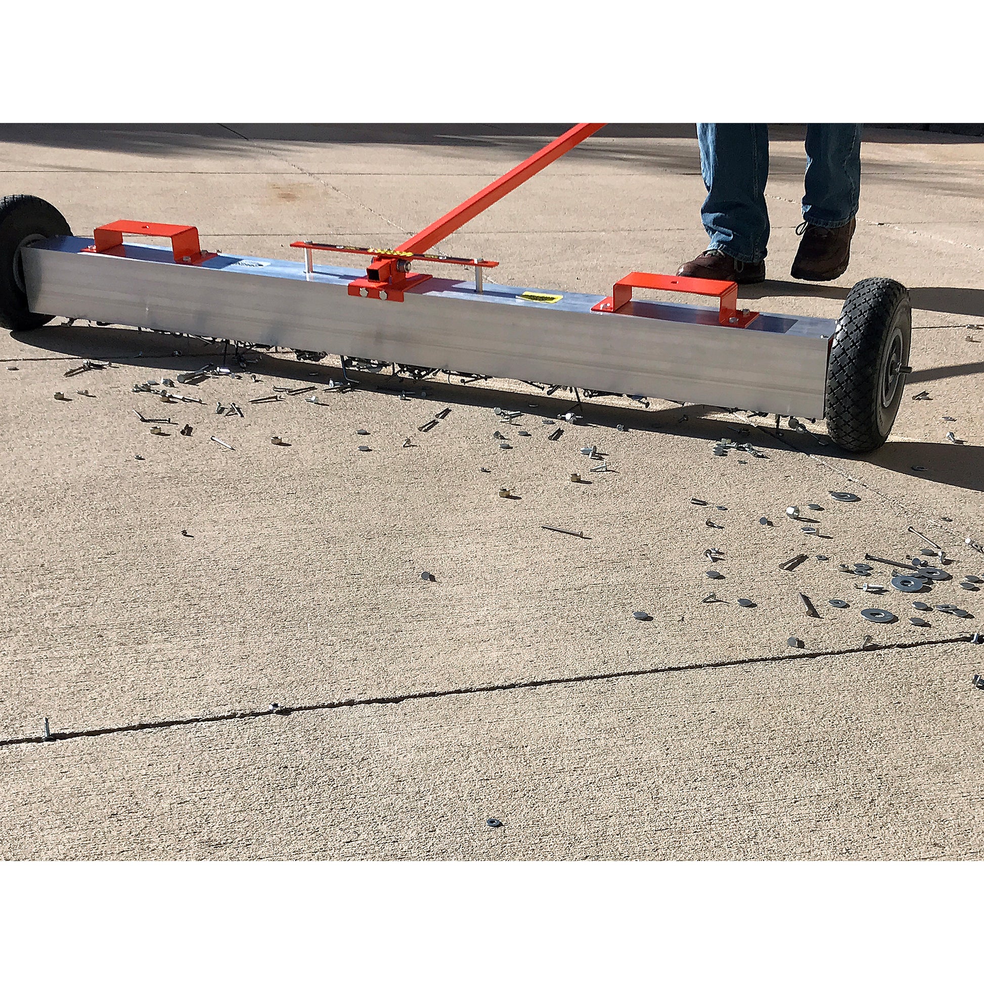 Load image into Gallery viewer, VSM-60 VersaSWEEP™ 4-in-1 Magnetic Sweeper with Quick Release - Closeup View of Man Sweeping Debris Off Sidewalk