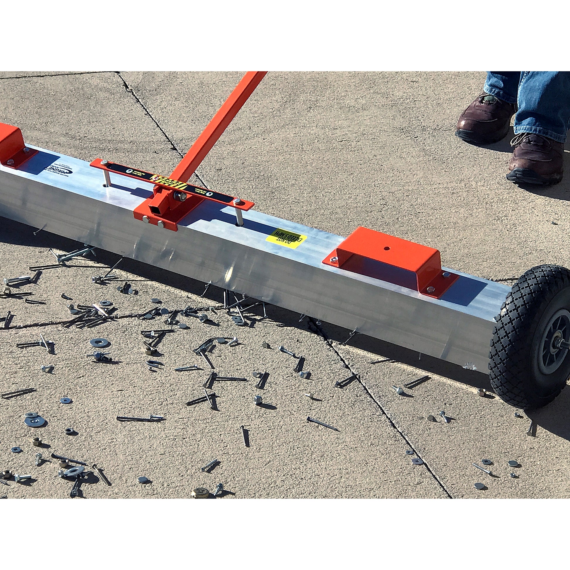 Load image into Gallery viewer, VSM-60 VersaSWEEP™ 4-in-1 Magnetic Sweeper with Quick Release - Closeup View of Sweeper Removing Debris from Sidewalk