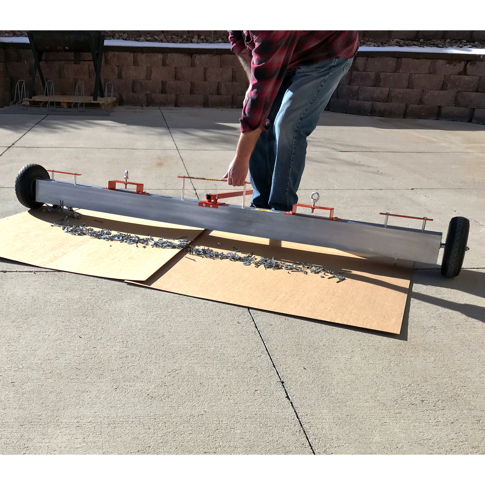 Load image into Gallery viewer, VSM-84 VersaSWEEP™ 4-in-1 Magnetic Sweeper with Quick Release - Pushing Large Debris on Cardboard