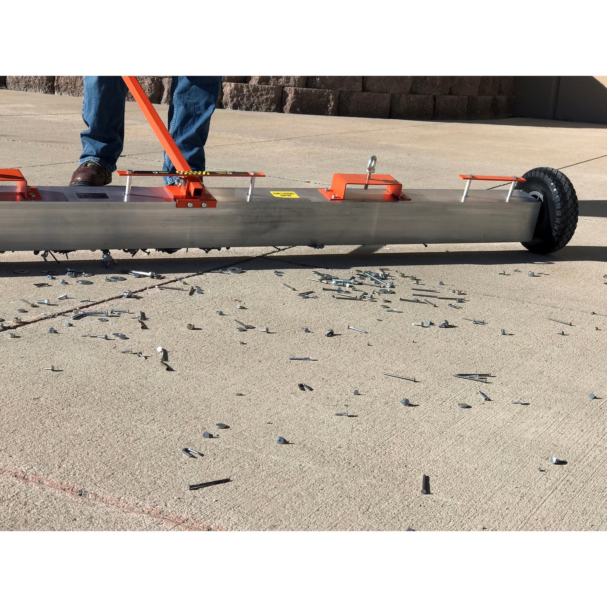 Load image into Gallery viewer, VSM-84 VersaSWEEP™ 4-in-1 Magnetic Sweeper with Quick Release - Closeup of Pushing Large Debris